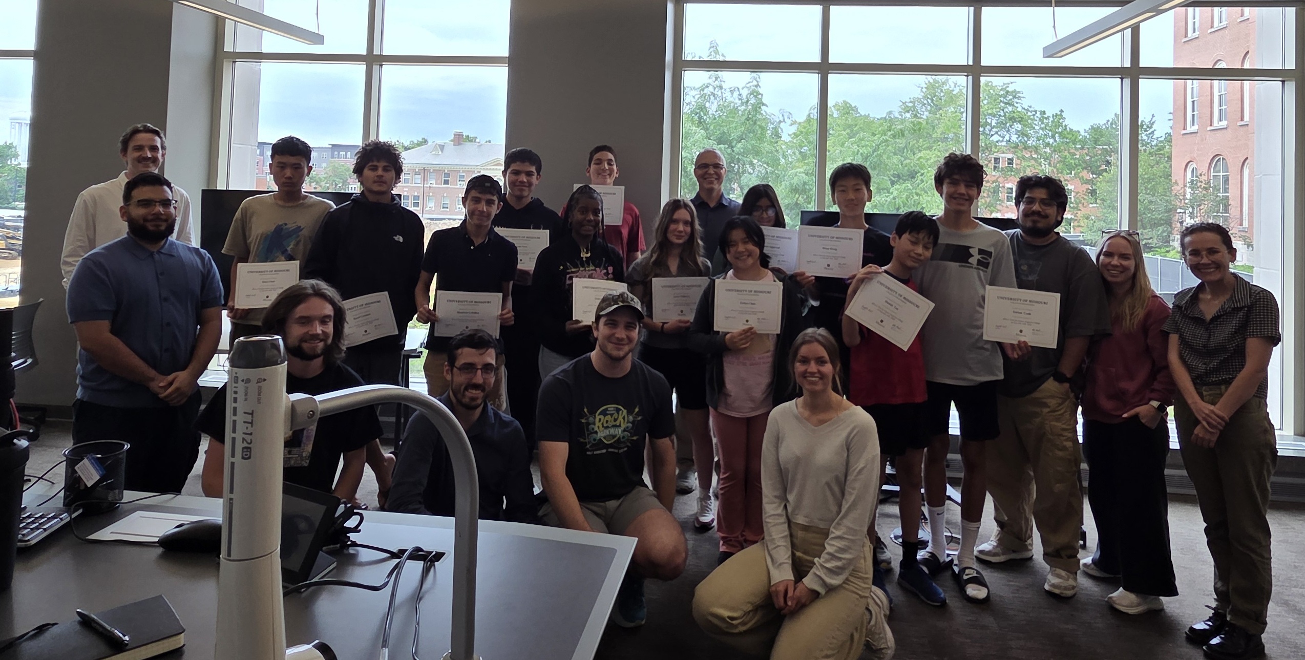 Camp participants and the instructional team with certificates of completion at the close of the program